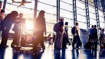 A group of people waiting at the airport to enter Germany